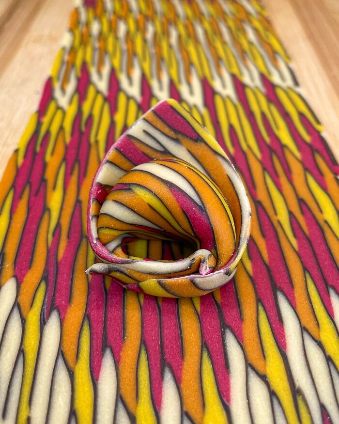 Colorful handcrafted pasta with intricate patterns, showcasing the artistry of a culinary chef.