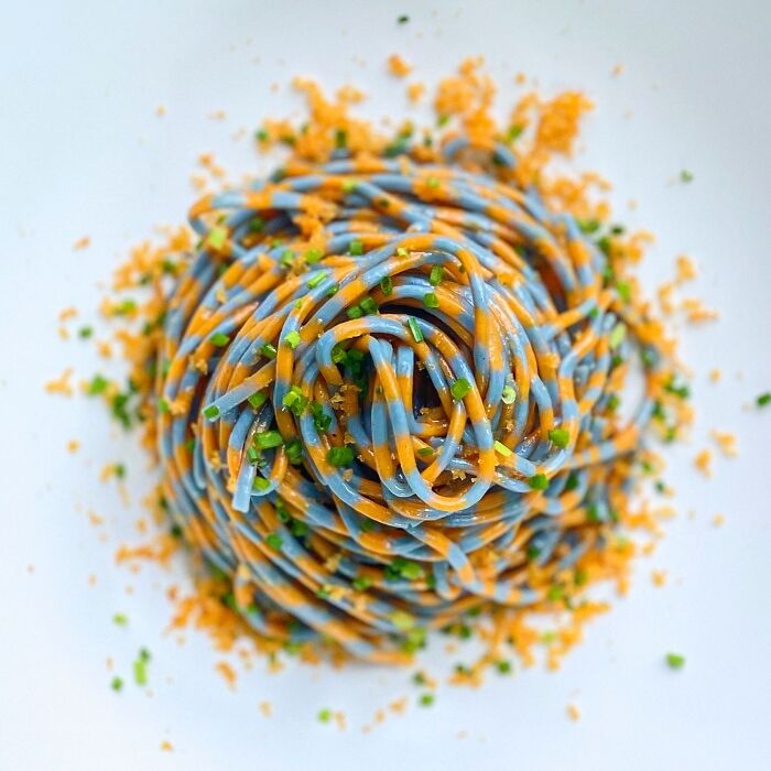 Colorful handcrafted pasta dish featuring intricate patterns and vibrant colors from a skilled culinary artist.