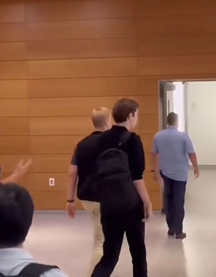 Person with a backpack in a college hallway escorted by another person, illustrating Secret Service safety methods. Person with a backpack in a college hallway escorted by another person, illustrating Secret Service safety methods.