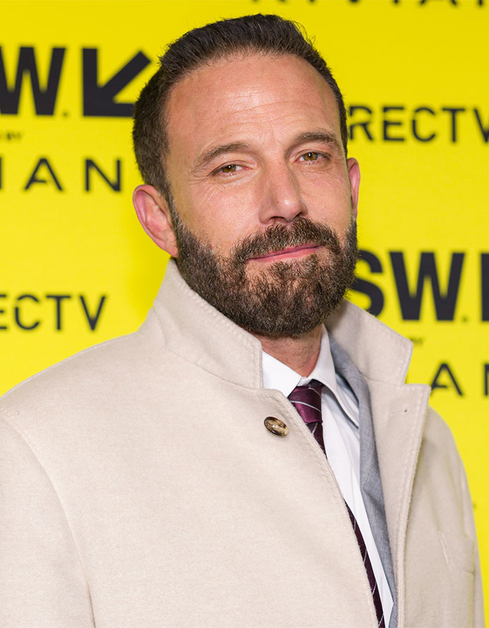 Ben Affleck in a white coat at an event, promoting the idea that rich kids work regular shop jobs. Ben Affleck in a white coat at an event, promoting the idea that rich kids work regular shop jobs.