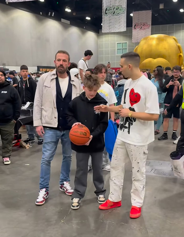 Ben Affleck with his children at a busy event, promoting hard work through regular jobs for rich kids. Ben Affleck with his children at a busy event, promoting hard work through regular jobs for rich kids.