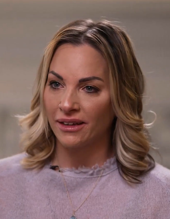 A woman discussing her experience with fertility fraud, wearing a light-colored top and a necklace. A woman discussing her experience with fertility fraud, wearing a light-colored top and a necklace.