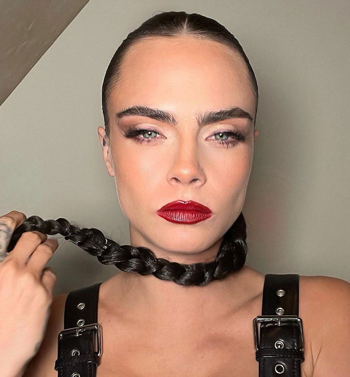 Woman in dramatic makeup with braided hair, showcasing transformation praised at Coachella 2025. Woman in dramatic makeup with braided hair, showcasing transformation praised at Coachella 2025.