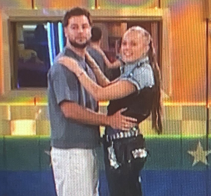 Two people sharing an intimate moment on Big Brother, embracing each other warmly. Two people sharing an intimate moment on Big Brother, embracing each other warmly.