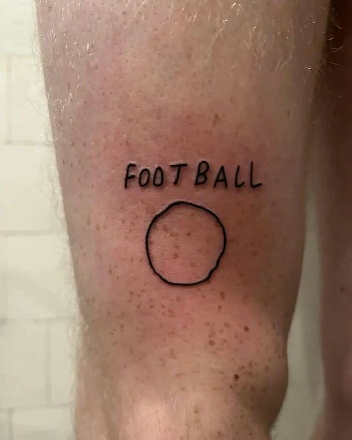 Bad tattoo with the word "FOOTBALL" above a simple circle on skin.
