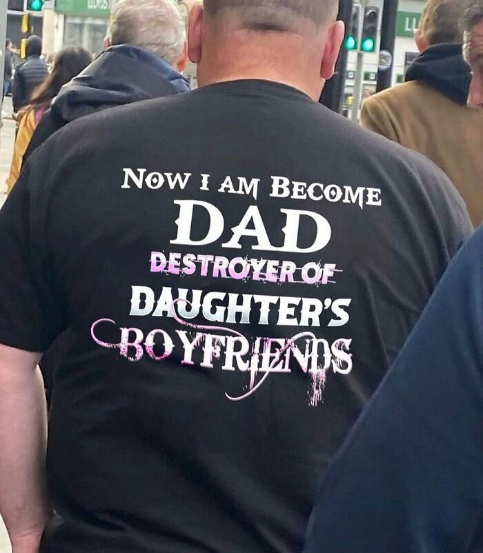 Back view of a person wearing a humorous t-shirt with text about being a dad, showcasing random cursed image humor.