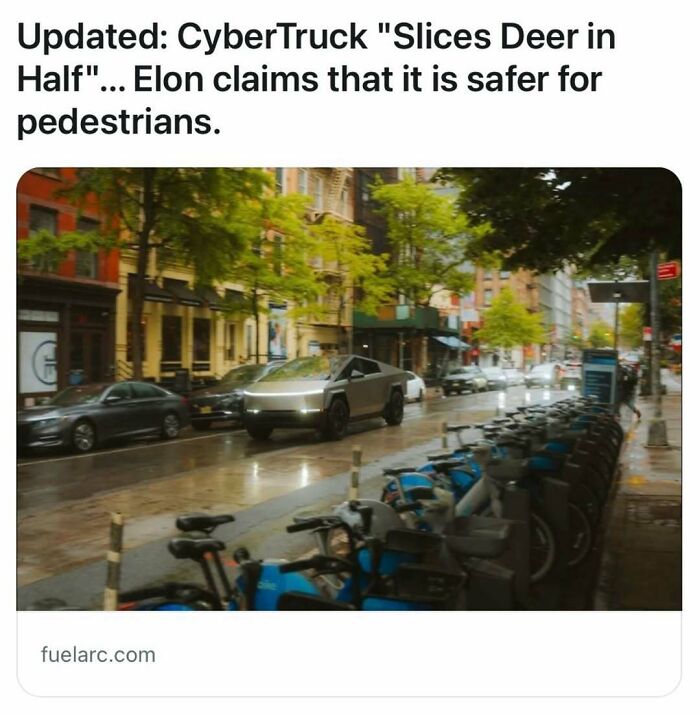 CyberTruck driving down a city street lined with parked rental bikes.