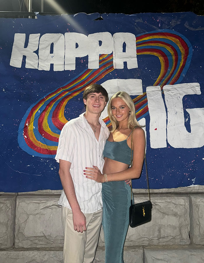 Young couple posing in front of a "Kappa" sign outside, related to Dave Portnoy rumor apology. Young couple posing in front of a "Kappa" sign outside, related to Dave Portnoy rumor apology.
