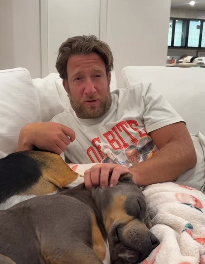 Man in a casual setting petting a dog, related to an apology about a rumor affecting a student. Man in a casual setting petting a dog, related to an apology about a rumor affecting a student.