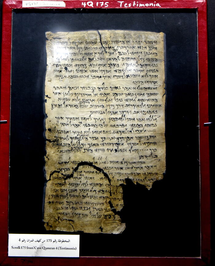 Ancient scroll, fragmentary text, displayed in a red frame. Historical document showcasing one of the world's oldest writings.