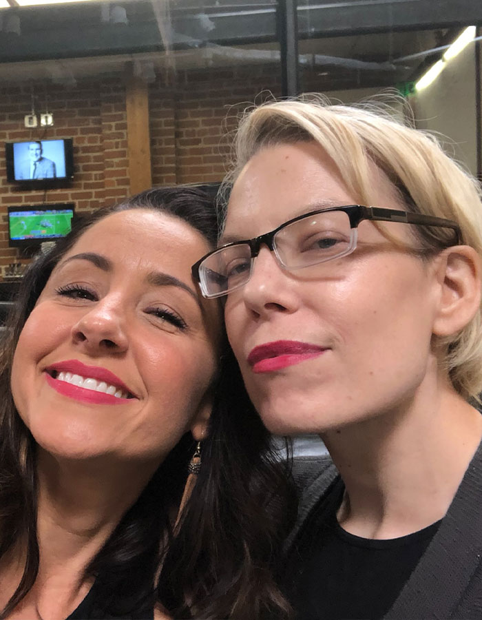 Two smiling women in a cozy indoor setting, related to a story about personal transformation after cancer diagnosis. Two smiling women in a cozy indoor setting, related to a story about personal transformation after cancer diagnosis.