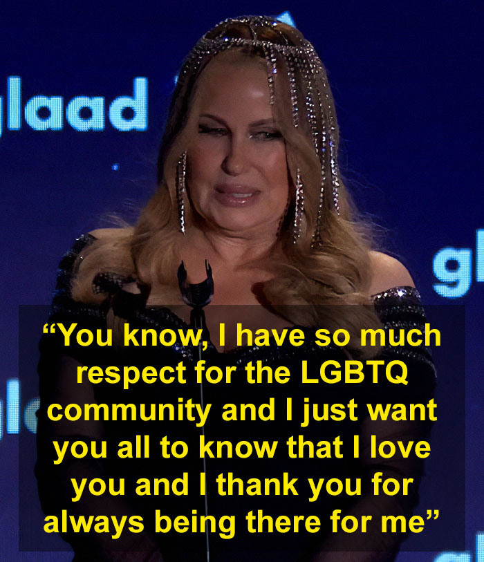 Woman expressing gratitude to LGBTQ+ fans at an event, wearing an elegant black dress and beaded hair accessory. Woman expressing gratitude to LGBTQ+ fans at an event, wearing an elegant black dress and beaded hair accessory.