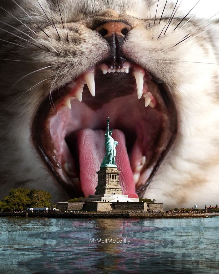 Giant cat with open mouth behind the Statue of Liberty, showcasing giant cat art in an unsettling yet adorable style.