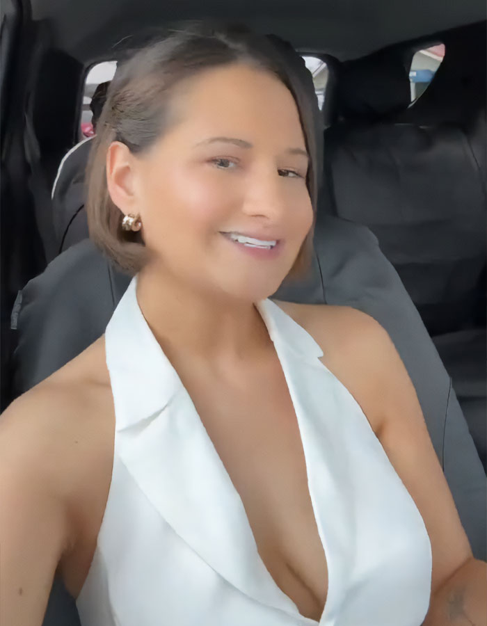 Woman in a car wearing a white top, smiling after weight loss transformation. Woman in a car wearing a white top, smiling after weight loss transformation.