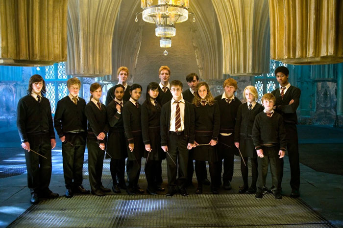 Harry Potter cast in Hogwarts attire under grand chandelier, representing movie scene ensemble. Harry Potter cast in Hogwarts attire under grand chandelier, representing movie scene ensemble.