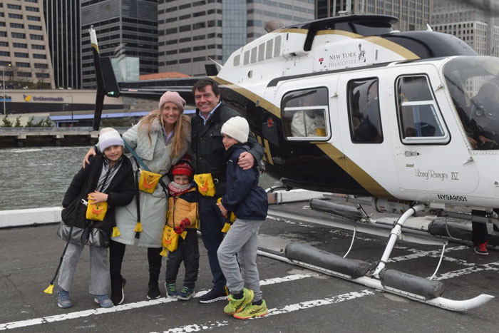 Family posing with helicopter near Hudson River, New York. Family posing with helicopter near Hudson River, New York.