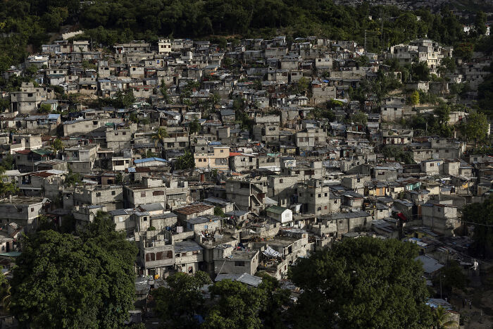 Aerial view of densely packed urban landscape with greenery, showcasing powerful imagery from Istanbul Photo Awards.