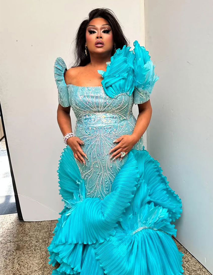 Jiggly Caliente in an ornate turquoise gown. Jiggly Caliente in an ornate turquoise gown.