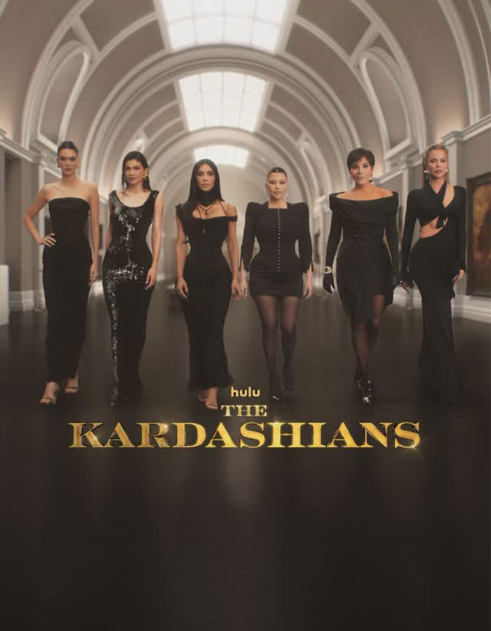 The Kardashians in black outfits walking in a grand hallway, linked to Crumbl's criticized new cookies. The Kardashians in black outfits walking in a grand hallway, linked to Crumbl's criticized new cookies.