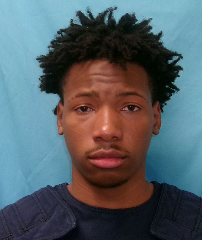 I don't know who this person is. Young man with short hair in a blue shirt, set against a light blue background. I don't know who this person is. Young man with short hair in a blue shirt, set against a light blue background.