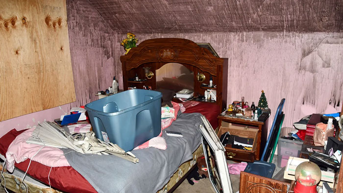 Cluttered bedroom with wooden headboard, storage bin, and disorganized items, linked to a "disgusting human" story. Cluttered bedroom with wooden headboard, storage bin, and disorganized items, linked to a "disgusting human" story.