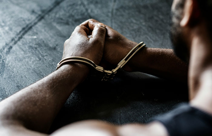 Man with hands tied, symbolizing cruelty. Man with hands tied, symbolizing cruelty.