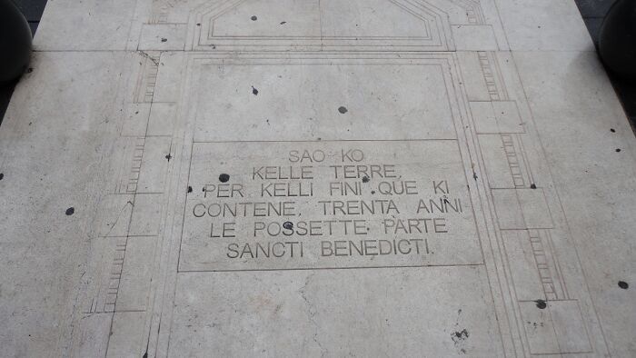 Ancient stone inscription with Latin text, representing one of the world's oldest written texts that survived.