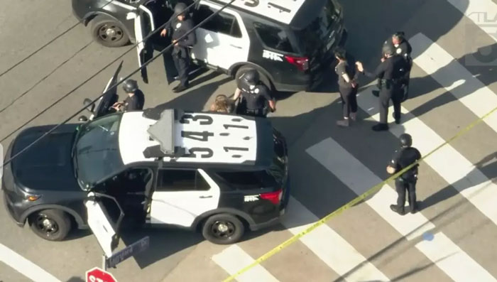 Police vehicles at the scene with officers; related to Weezer bassist's statement after shooting incident. Police vehicles at the scene with officers; related to Weezer bassist's statement after shooting incident.