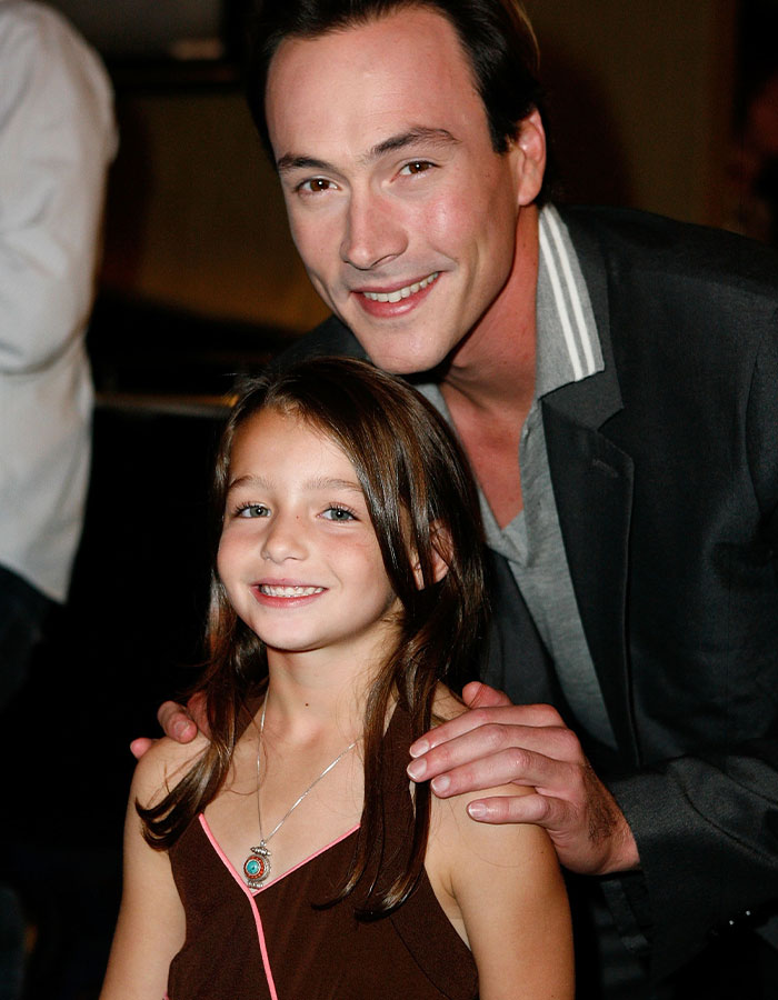 A former child star smiling at an event, highlighting mystery surrounding her recent passing. A former child star smiling at an event, highlighting mystery surrounding her recent passing.