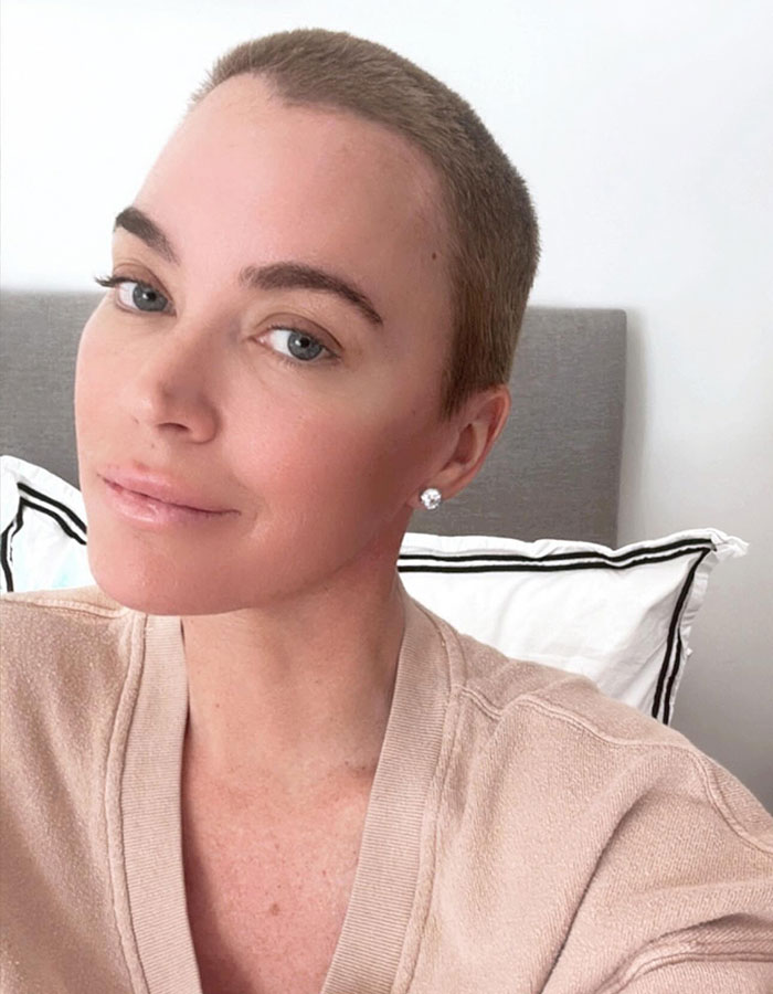 Woman in a beige sweater with short hair, smiling softly, symbolizing hope during a cancer battle. Woman in a beige sweater with short hair, smiling softly, symbolizing hope during a cancer battle.
