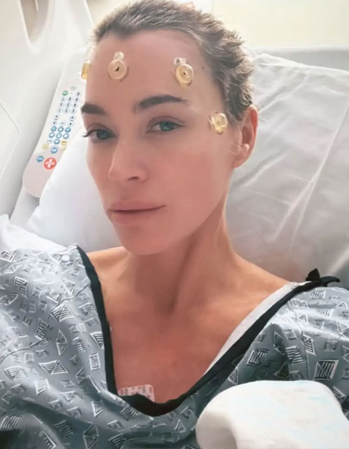 Teddi Mellencamp in hospital bed, showing resilience amid cancer battle. Teddi Mellencamp in hospital bed, showing resilience amid cancer battle.