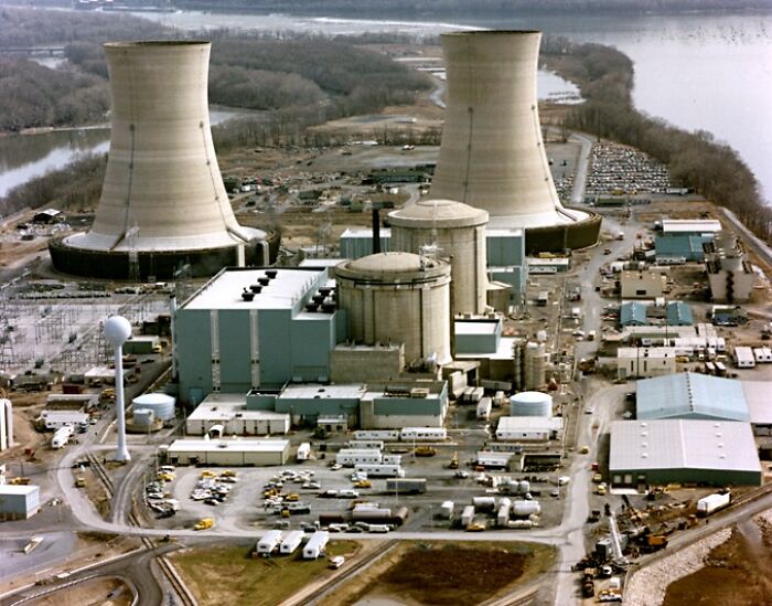 Aerial view of a nuclear power plant; a notable coincidence in history, showing cooling towers and surrounding facilities.