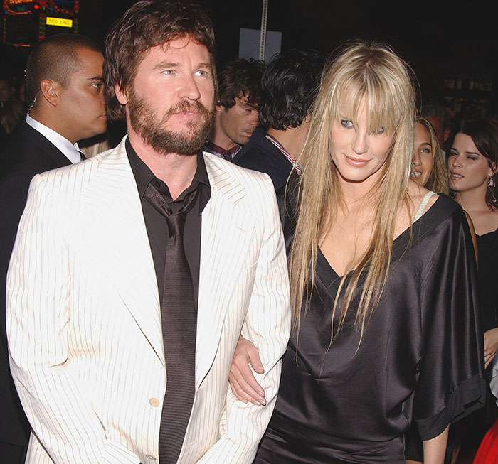 A man in a white suit with a woman in black attire, highlighting Hollywood beauties theme. A man in a white suit with a woman in black attire, highlighting Hollywood beauties theme.