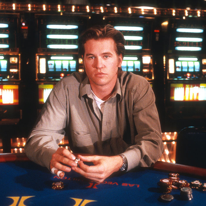 Legendary actor at a poker table with slot machines in the background. Legendary actor at a poker table with slot machines in the background.