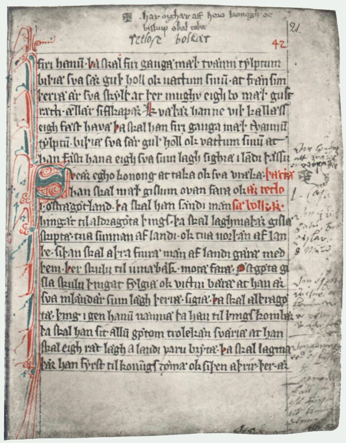 Oldest written text with decorative red and blue initials, showcasing medieval handwriting on aged parchment.