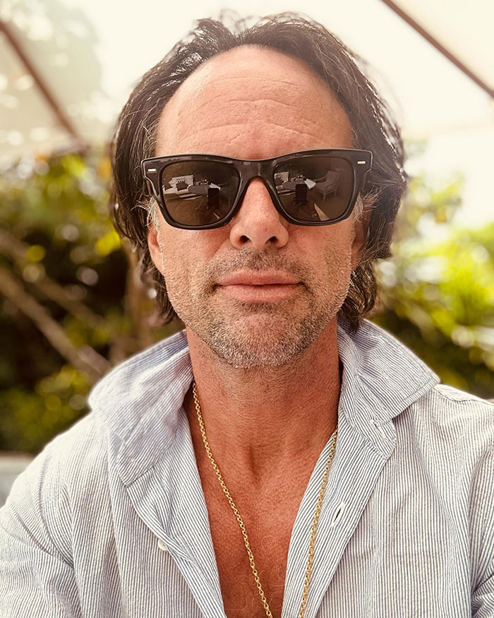 Man in sunglasses and a striped shirt in an outdoor setting, related to stunning photoshoot themes. Man in sunglasses and a striped shirt in an outdoor setting, related to stunning photoshoot themes.