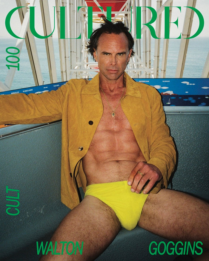 Walton Goggins in yellow swimwear and a tan jacket posing confidently on a magazine cover. Walton Goggins in yellow swimwear and a tan jacket posing confidently on a magazine cover.