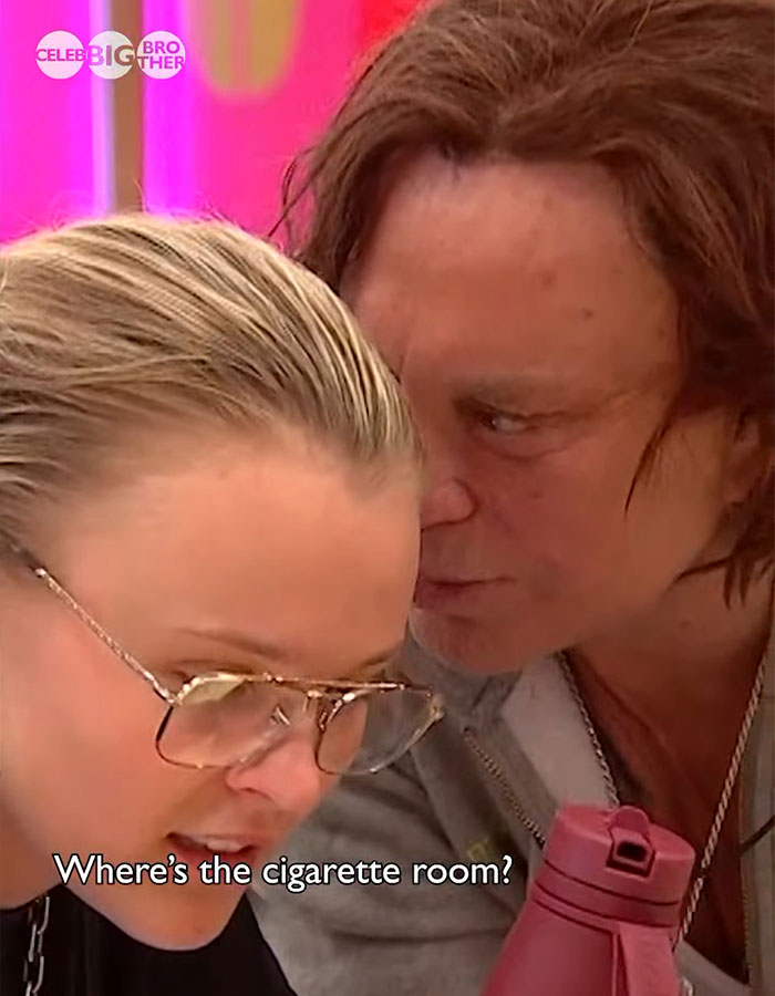 Two people conversing closely on 'Celebrity Big Brother', one holding a pink bottle. Two people conversing closely on 'Celebrity Big Brother', one holding a pink bottle.