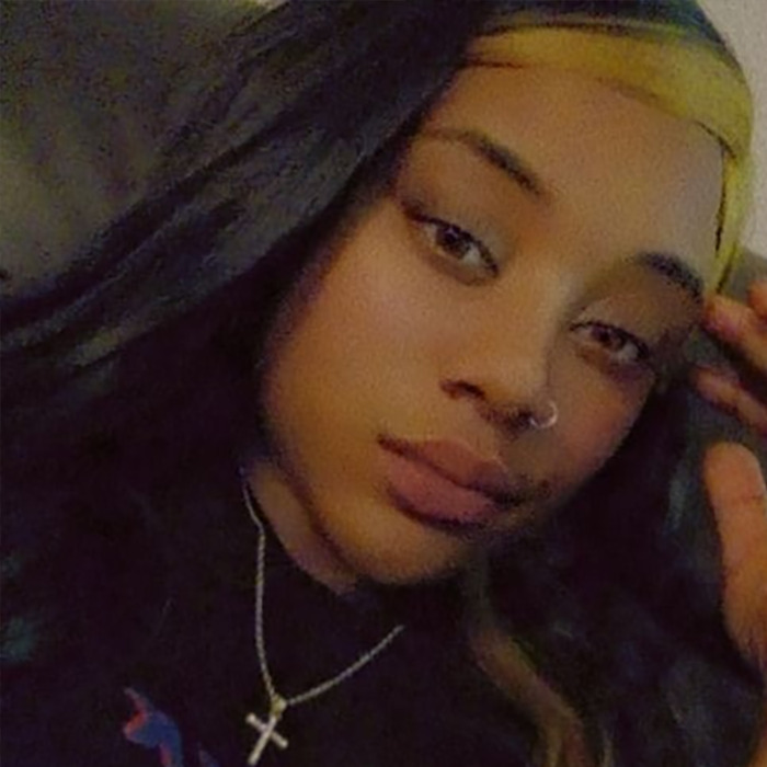 Black woman with long hair and a cross necklace, related to viral video incident. Black woman with long hair and a cross necklace, related to viral video incident.