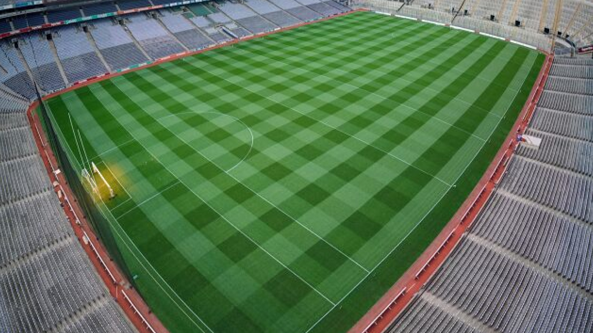 Aerial view of a large soccer stadium with empty stands and a well-maintained pitch in cathedrals of soccer.