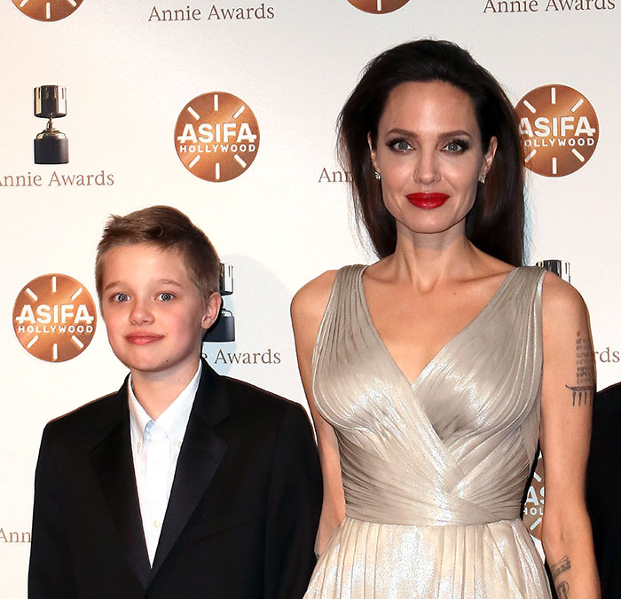 Angelina Jolie with her daughter Shiloh, showcasing a new look at an award event. Angelina Jolie with her daughter Shiloh, showcasing a new look at an award event.