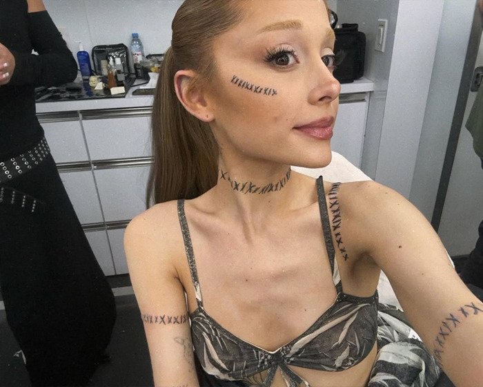 Ariana Grande shows off tattoos and new hairstyle in a stylish outfit. Ariana Grande shows off tattoos and new hairstyle in a stylish outfit.