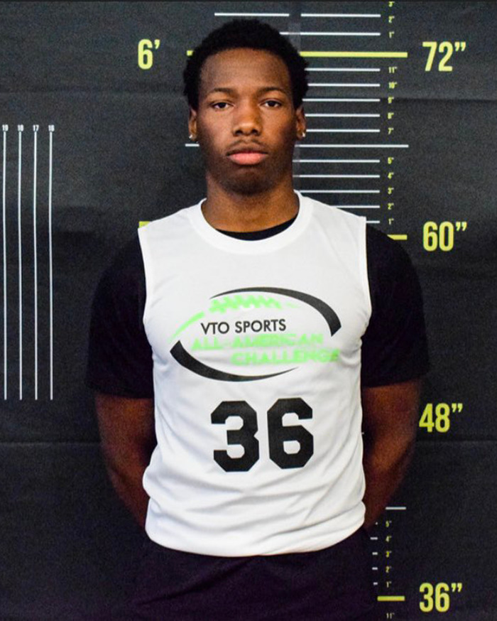 Young athlete in sports vest standing against height measurement backdrop, related to Austin Metcalf conspiracy theory. Young athlete in sports vest standing against height measurement backdrop, related to Austin Metcalf conspiracy theory.