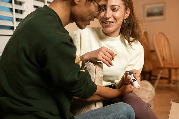 Couple discussing pregnancy test in living room, highlighting concerns about marriage and last names. Couple discussing pregnancy test in living room, highlighting concerns about marriage and last names.