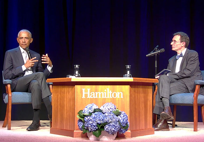Barack Obama speaking on stage at a Hamilton event, engaging in a discussion about his marriage. Barack Obama speaking on stage at a Hamilton event, engaging in a discussion about his marriage.