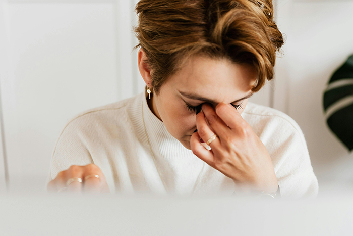 Bride stressed after hearing news about fiancé and friend's bet, wearing a white sweater, sitting with head in hand. Bride stressed after hearing news about fiancé and friend's bet, wearing a white sweater, sitting with head in hand.