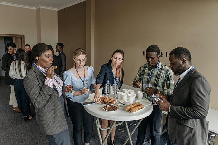 People enjoying snacks and drinks at a social event, discussing wedding plans and relationships. People enjoying snacks and drinks at a social event, discussing wedding plans and relationships.