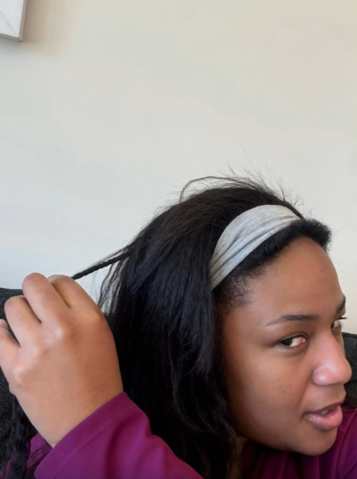 Woman reveals her braided hair, looking surprised after a flight. Woman reveals her braided hair, looking surprised after a flight.