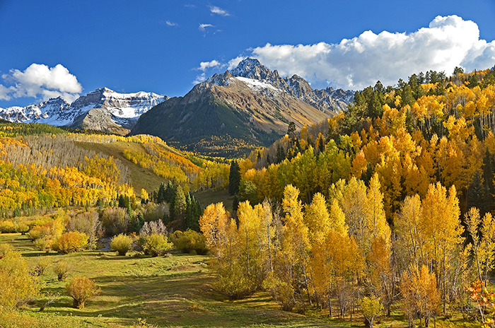 Mountain landscape with autumn trees and a clear blue sky, illustrating a serene vacation backdrop. Mountain landscape with autumn trees and a clear blue sky, illustrating a serene vacation backdrop.