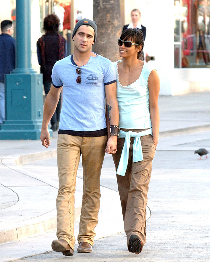 Two people walking outdoors, wearing casual clothing, with sunglasses and hats. Two people walking outdoors, wearing casual clothing, with sunglasses and hats.